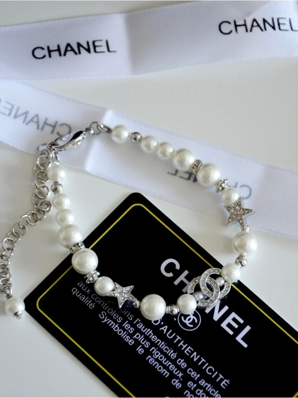 CHANEL Pearl Bracelet with Crystal CC Logo and Star Accents in White and Silver